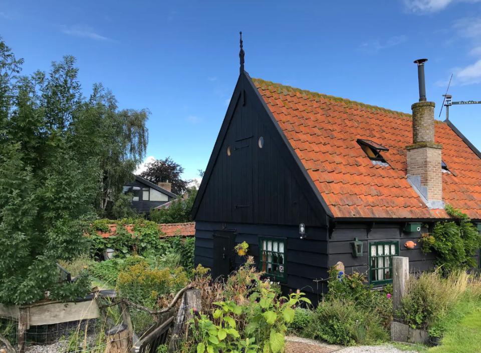 Klein houten huisje met groene bomen
